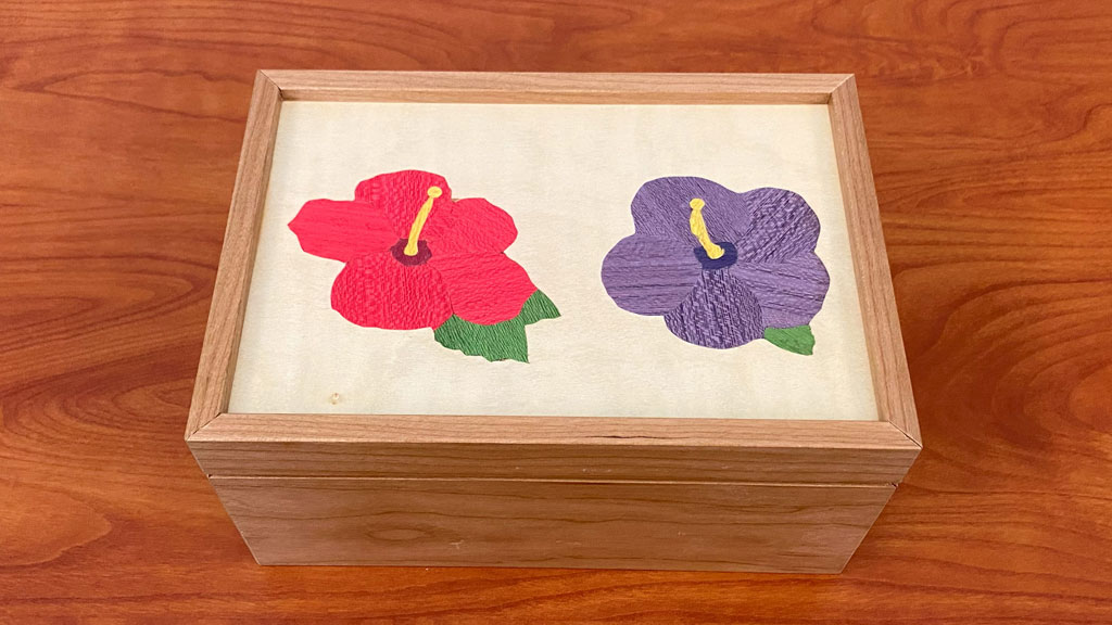 A box made from Koa wood with two Hibiscus flower inlay hand-made by Lloyd Worthington-Levy.